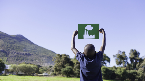 Young African boy holding up a factory cut out. Cape Town, Western Cape, South Africa