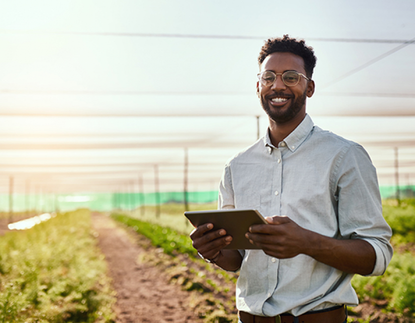 Cropped portrait of a handsome young male farmer using a tablet while working on his farm
