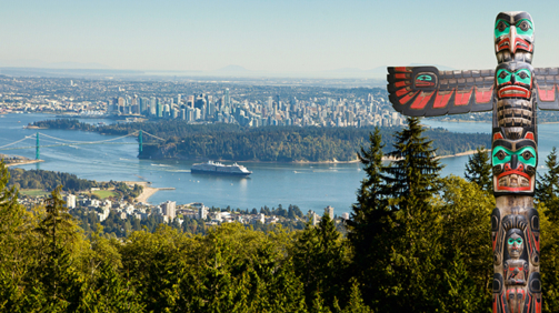 Vancouver as seen from viepoint  on the road to Cypress bowl. First nation totem pole in the front
