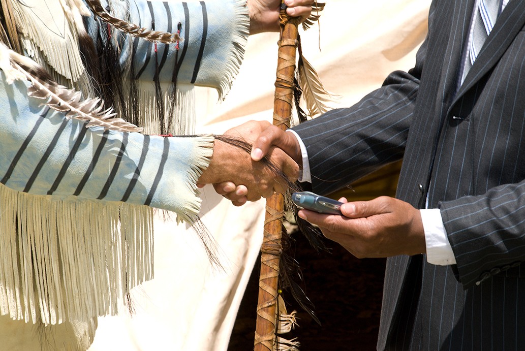 Indian Chief Shaking hands with a businessman.