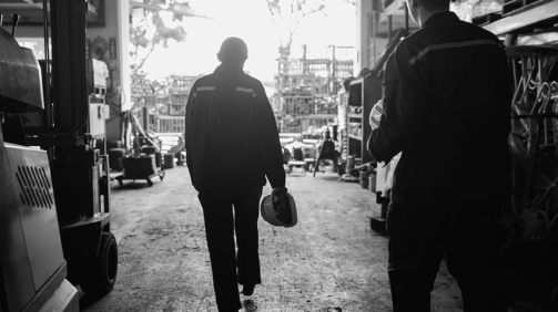 Mental health and wellbeing - A pair of Asian factory coworkers stepping out for a rest