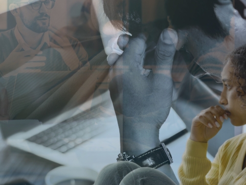 Picture of guy looking depressed in front of laptop - mental health.