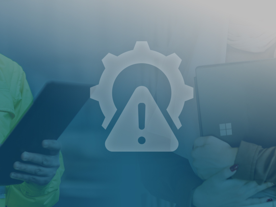 Two technicians using tablets with a large warning and gear icon overlay in the foreground (IT maintenance vibe).